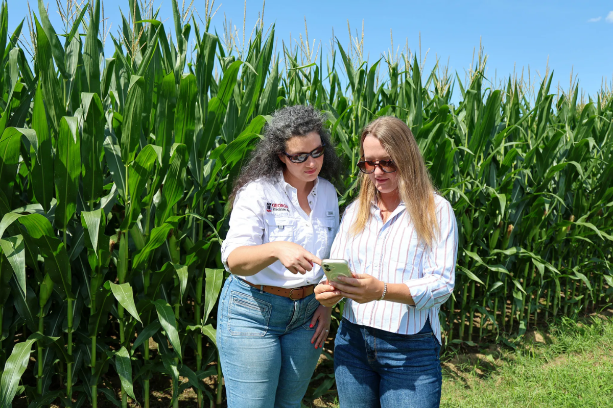 UGA Student Industry Fellow Bradley Smith, right, speaks with Lauren Lazaro, assistant professor and UGA Extension precision agriculture specialist, about FieldLog at the UGA Tifton Campus. (Photo by Beth Anne DeKeizer)